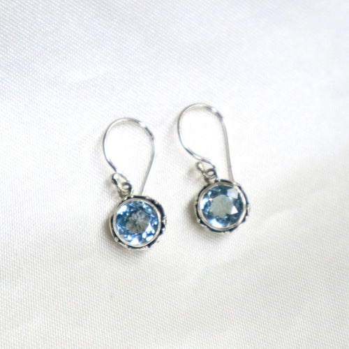 Sterling Silver Swirl Design Dangle Earrings set with Faceted Blue Topaz - The Gem Mine